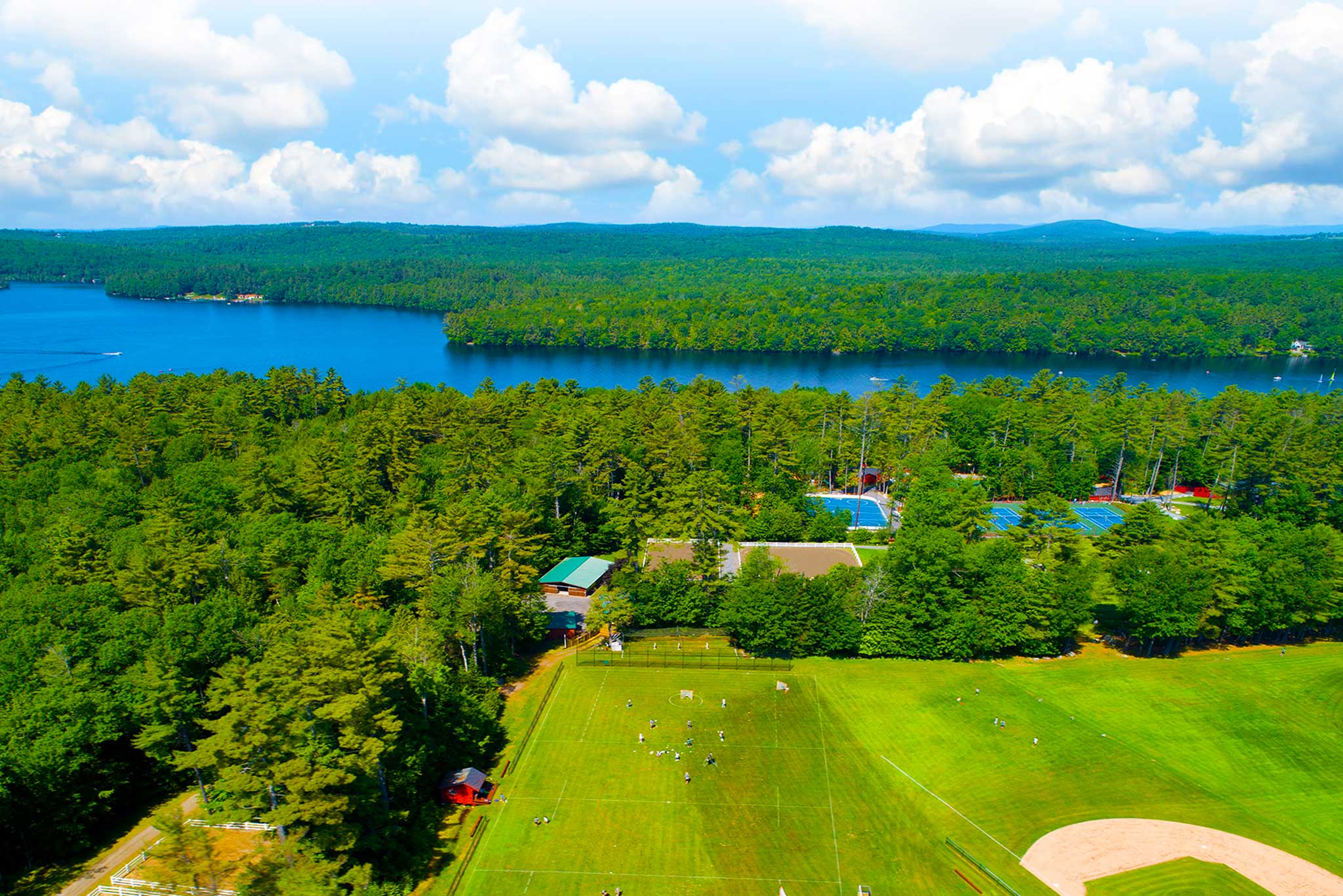 Summer camp waterfront and open field at golden hour